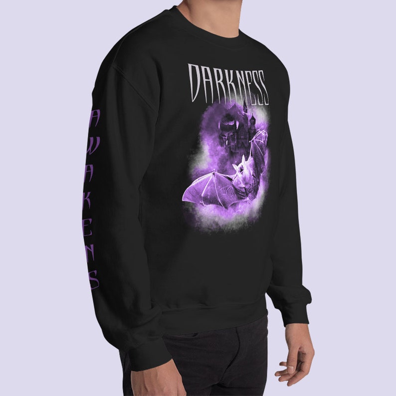 May include: Black sweatshirt with a purple bat graphic and the text "DARKNESS AWAKENS" on the sleeves.