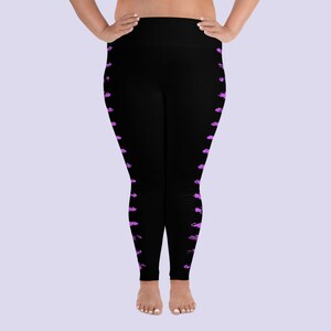 May include: Black leggings with a purple abstract pattern on the sides.