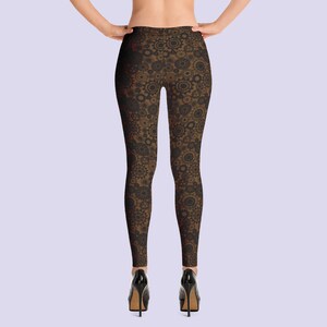 May include: Black leggings with a brown and gold gear pattern.