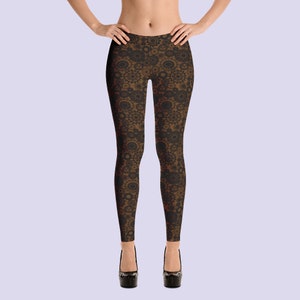 May include: Black leggings with a brown and black geometric pattern. The pattern features repeating circles and swirls.