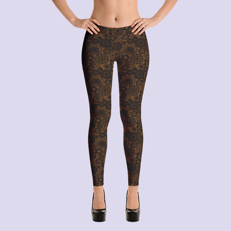 May include: Black leggings with a brown and black geometric pattern. The pattern features repeating circles and swirls.