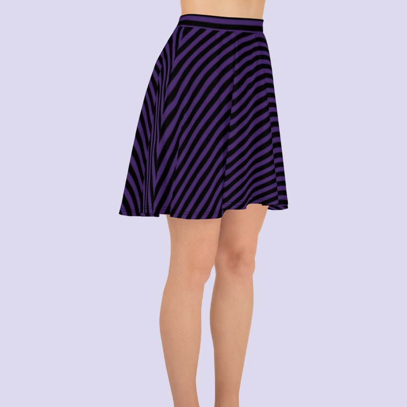 May include: A purple and black striped skater skirt. The skirt is made of a stretchy fabric and has a flared silhouette.