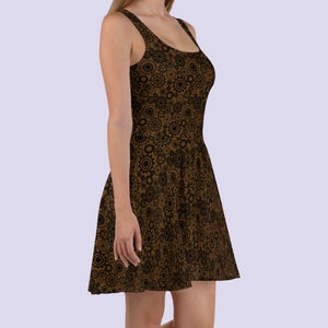 May include: A brown skater dress with a black and brown gear pattern.