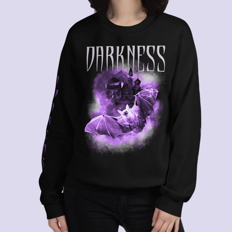 May include: Black sweatshirt with a purple bat and castle graphic. The text "DARKNESS" is printed in white on the front of the sweatshirt.
