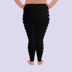 May include: Black leggings with a pink abstract pattern on the sides. The leggings are a stretchy material and have a high waist.
