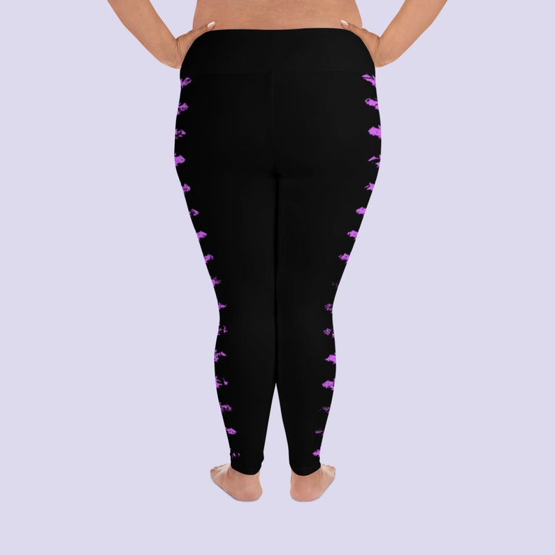 May include: Black leggings with a pink abstract pattern on the sides. The leggings are a stretchy material and have a high waist.