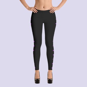 May include: Black leggings with a pink floral pattern on the sides.