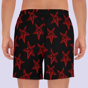 May include: Black athletic shorts with a red pentagram pattern.