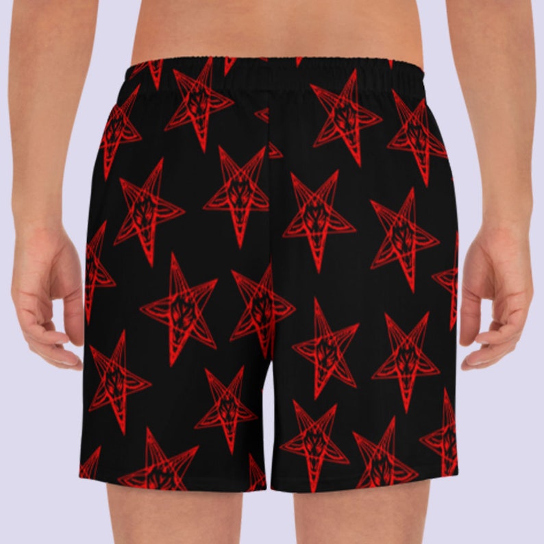 May include: Black athletic shorts with a red pentagram pattern.