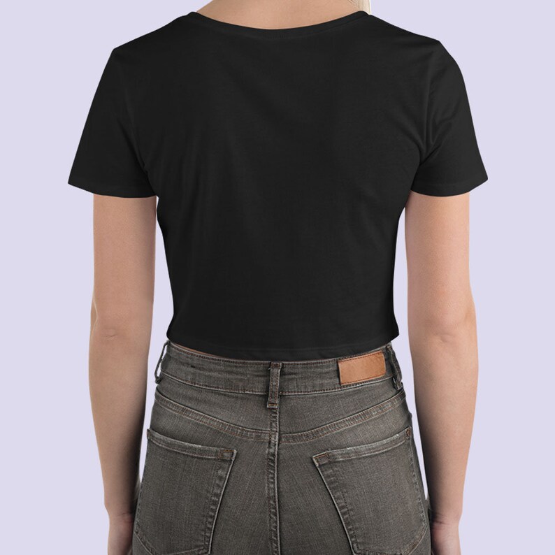 May include: A black cropped t-shirt with short sleeves. The shirt is made of a soft, comfortable material and has a relaxed fit.