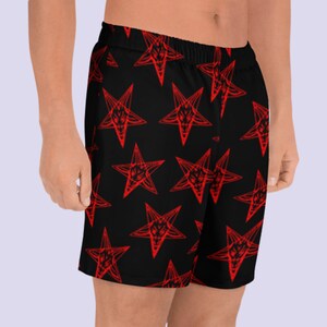 May include: Black athletic shorts with a red pentagram pattern.