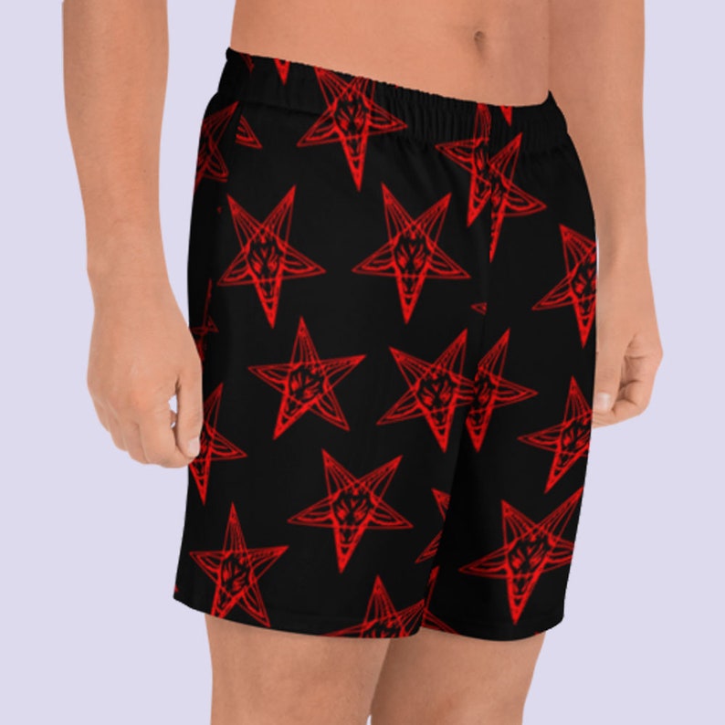 May include: Black athletic shorts with a red pentagram pattern.