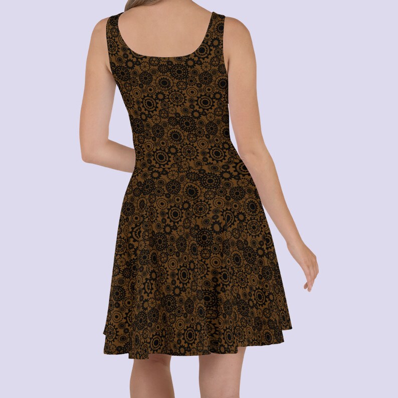 May include: A brown sleeveless dress with a black and brown gear pattern. The dress has a fitted bodice and a flared skirt.