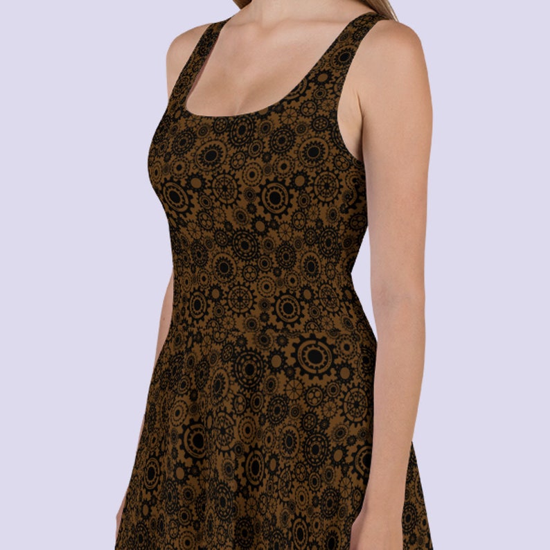 May include: A brown sleeveless dress with a black and brown gear pattern. The dress has a scoop neck and a fitted bodice.