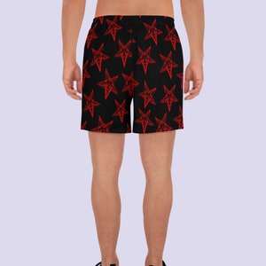 May include: Black athletic shorts with a red pentagram pattern.