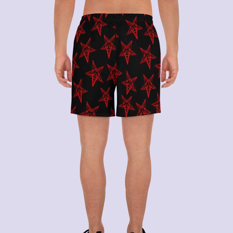 May include: Black athletic shorts with a red pentagram pattern.