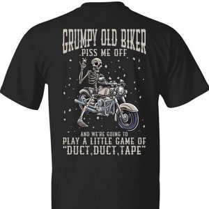 May include: Black t-shirt with a graphic of a skeleton riding a motorcycle. The text "Grumpy Old Biker" is above the skeleton and the text "Piss Me Off" is below the skeleton. The text "And we're going to play a little game of "DUCT, DUCT, TAPE" is below the motorcycle.