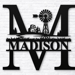 May include: Black metal monogram with the letter M, a silhouette of a tractor and windmill, and the name MADISON below.