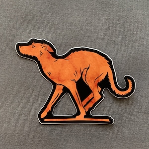 May include: A sticker of a stylized orange-brown dog running to the right. The dog has a long tail and is outlined in black.