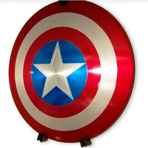 May include: A red, white, and blue Captain America shield with a five-pointed star in the center. The shield is made of metal and has a shiny finish.