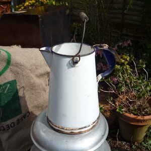 Vintage Enamelware Milk Jug/Pitcher in Blue and White. Beautifully vintage worn/ Still has original metal and wooden handle