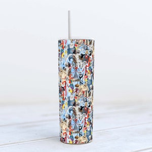 May include: A stainless steel tumbler with a white straw. The tumbler is covered in a colorful pattern of cartoon characters.