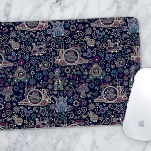 May include: A dark blue mouse pad with a colorful pattern of stars, swirls, and the text "Main Street Electrical Parade".
