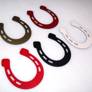 May include: Six different coloured horseshoes, each with a different colour: red, brown, black, white, and two shades of red.