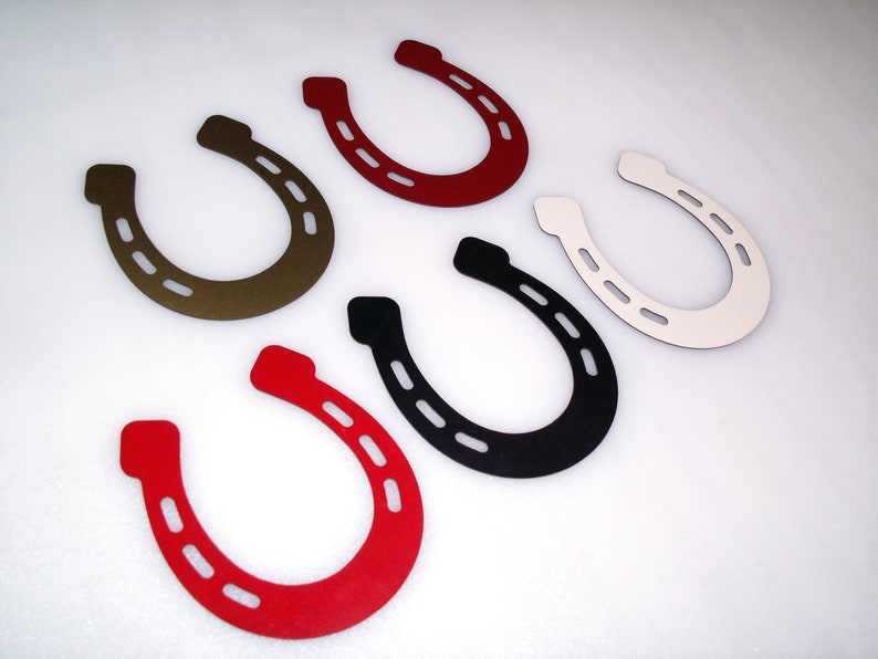 May include: Six different coloured horseshoes, each with a different colour: red, brown, black, white, and two shades of red.
