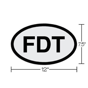 May include: White oval sticker with black outline and the text "FDT" in black lettering. The sticker is 7.5 inches tall and 12 inches wide.