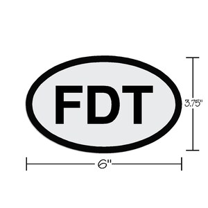 May include: White oval sticker with black outline and the text "FDT" in black lettering. The sticker is 6 inches wide and 3.75 inches tall.