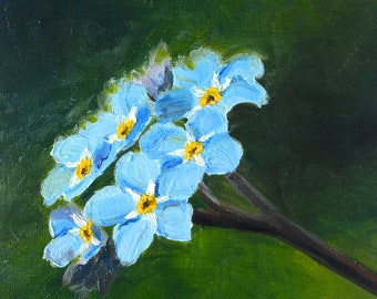 Puede incluir: Pintura original de flores nomeolvides. La obra presenta un grupo de flores azul claro con centros amarillos, sobre un fondo verde. La firma del artista, "Christa", es visible en la esquina inferior derecha.