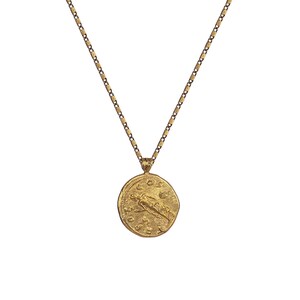 May include: A gold chain necklace with a round pendant featuring a detailed image of a winged figure and Roman numerals.