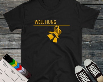 May include: Black t-shirt with the text "WELL HUNG" in yellow, with a yellow spotlight hanging below the text.