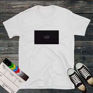 May include: White t-shirt with a black rectangle on the front that says "1,77:1 (16x9)".