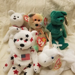 Grupa 5 RARE Beanie Babies: Glory, Erin, Valentino, Mystic i Peace. Sprawdź moje inne oferty, aby poznać możliwe kombinacje! Darmowa wysyłka!
