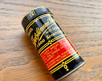 Vintage Zenith Tibet Almond Stick, Advertises Will Efface 1,000 Scratches.  Black and Red Tin With Yellow. 3/4 Full. 