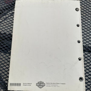 May include: A white Harley-Davidson motorcycle service manual with the Harley-Davidson logo and the text "Part No. 99545-97 Printed in U.S.A." and "Harley-Davidson Motor Company Technical Communications Milwaukee, WI 53201 U.S.A."