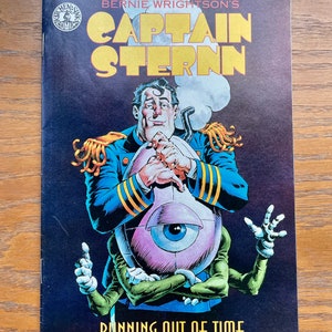 May include: Comic book cover featuring a blue-clad superhero, Captain Sternn, holding a large, pink, one-eyed creature. The cover text reads "Bernie Wrightson's Captain Sternn" and "Running Out of Time".