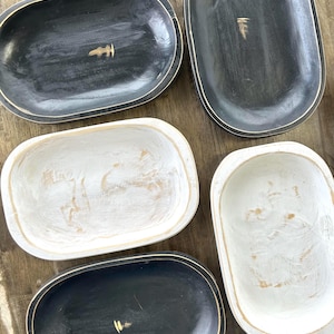 May include: Five wooden dough bowls in various sizes. Two are painted black with a distressed finish, and three are painted white with a distressed finish.
