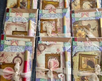 May include: A collection of vintage-themed scrapbooking kits. Each kit is packaged in a clear plastic sleeve and includes decorative papers, framed images, lace doilies, pens, and ribbons. The kits feature floral and antique clock designs.