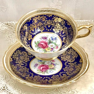 Rare Paragon Tea Cup: Double Warrant, Gold Handle & Pedestal Base, Royal Blue with Gold Overlaid Scrollwork, Pink Rose Bouquets
