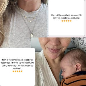 May include: A delicate gold-toned necklace featuring a small heart charm flanked by two letter charms, E and K, suspended on a thin chain. The necklace is worn layered with a second chain featuring two rectangular vertical bar pendants.