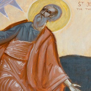 May include: An icon painting of a saint with a long white beard, wearing a red robe and a blue undergarment. A yellow halo surrounds the saint's head. The background is a light beige color with the text "ST JO" visible.