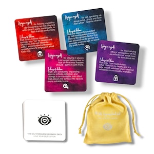 May include: A set of self-forgiveness oracle cards with a yellow pouch. The cards feature watercolor backgrounds with inspirational messages and affirmations. The pouch has a silver eye with a heart inside.