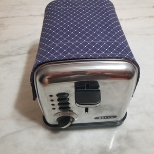 Toaster Cover Keep dust away with a Toaster Huggee® toaster cover today! Two Sizes to Choose From