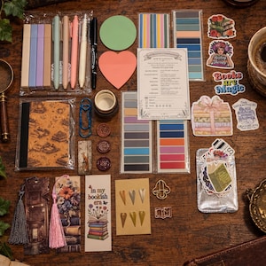 May include: A collection of stationery items including pastel highlighters, pens, sticky notes in circle and heart shapes, a reading companion guide, colorful page markers, book-themed stickers, bookmarks with tassels, and metal paper clips.