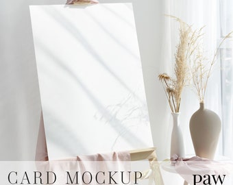 Welcome Sign Mockup On Wooden Easel With Pink Scarf, Beige And White Vases On Round Coffee Table, Styled Card Mockup, Wedding Sign Mockup