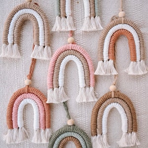 May include: A set of three ceramic mugs with a speckled, matte finish. The mugs are in shades of cream, light gray, and dark gray. Each mug has a simple, minimalist design, perfect for coffee or tea.