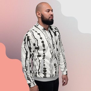 May include: A white bomber jacket with a black and white abstract print. The jacket has a zipper closure and a ribbed collar, cuffs, and hem.